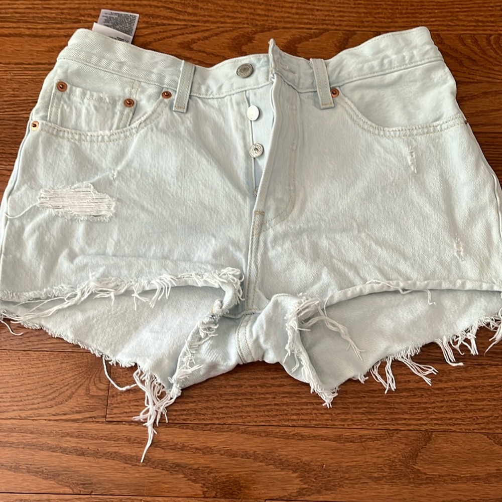 Never worn.  Levi’s light wash denim